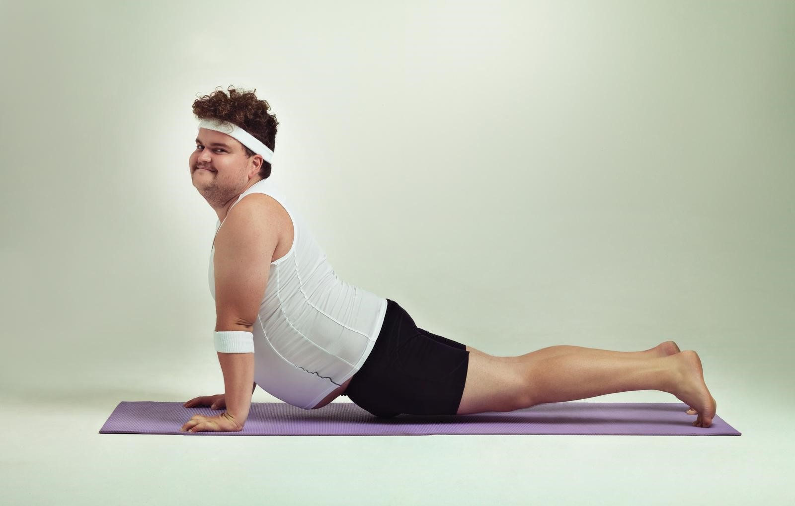 This upward facing dog pose is great. Shot of an overweight man doing yoga poses.